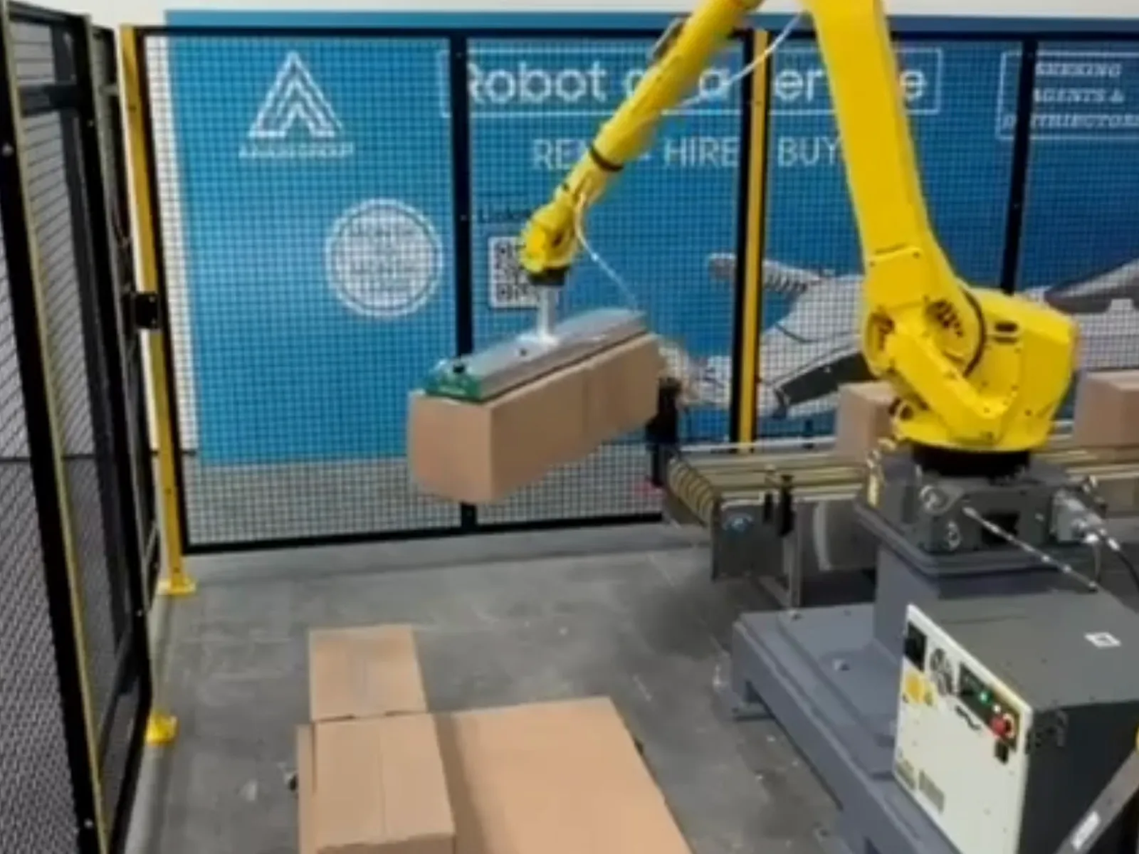 AAA20 palletizing cell with custom end-of-arm tooling picking two cases at once.